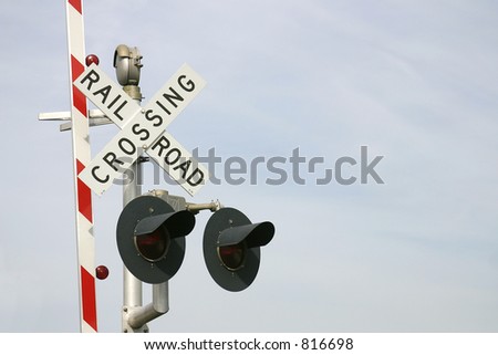 Railroad crossing sign with two warning lights and the red & white road barrier raised. Photo ID: RailroadSign00001