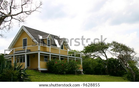 old Florida Beach House and wind-blown tree isolated against a white sky PHOTOID: Beach-House00002