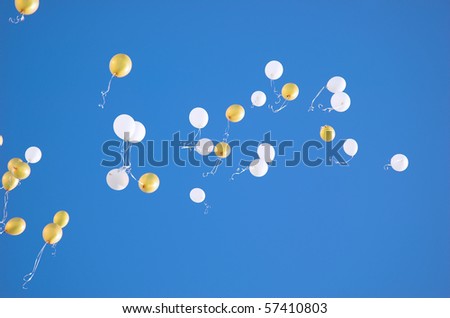 white and yellow balloons in the sky
