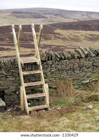 Ladders on a public right of way over a wall in the hills
