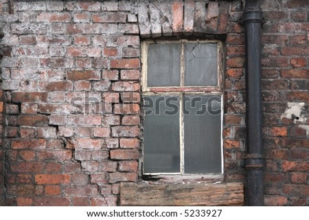 Old window and brick wall in poor repair
