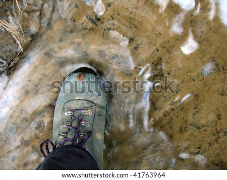 Muddy walking boot in stream