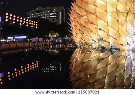 HONG KONG, CHINA - OCT 1: Traditional Chinese lanterns with height over 10m light up with reflection on water in Victoria Park to celebrate the mid-autumn festival on 1st October, 2012 in Hong Kong