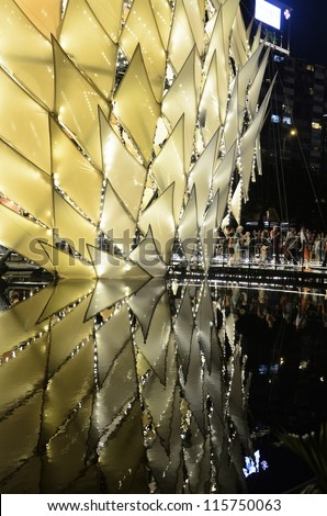 HONG KONG, CHINA - OCT 1: Traditional Chinese lanterns with height over 10m light up with reflection on water in Victoria Park to celebrate the mid-autumn festival on 1st October, 2012 in Hong Kong