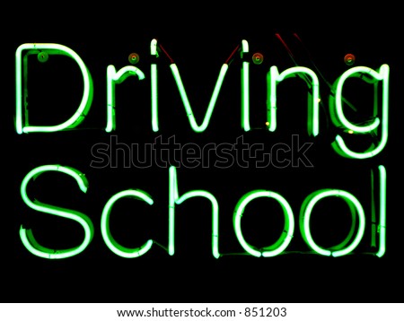 Green neon sign advertising driving school