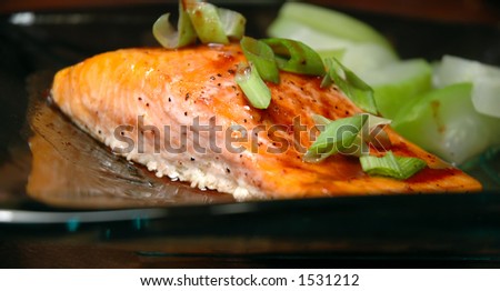 Glass plate with a steelhead trout fillet and steamed summer squash