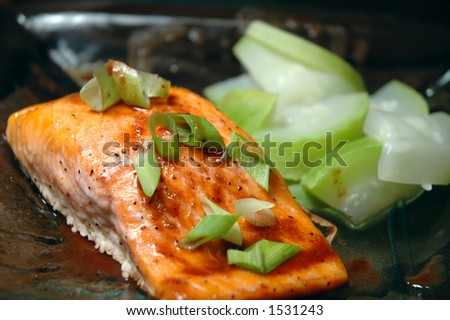 Glass plate with a steelhead trout fillet and steamed summer squash
