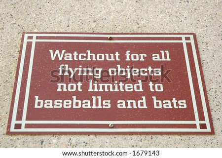 Watch Out for Flying Objects sign at a baseball park
