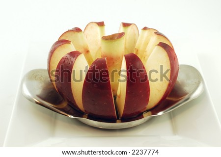 Cored red delicious apple on a white plate isolated on a white background