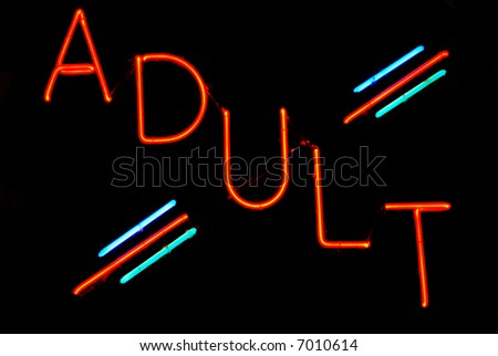 Illuminated adult neon sign on black background