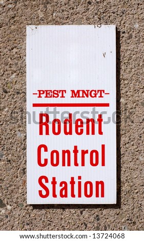 Sign reading Pest Mgmt Rodent Control Station on a wall