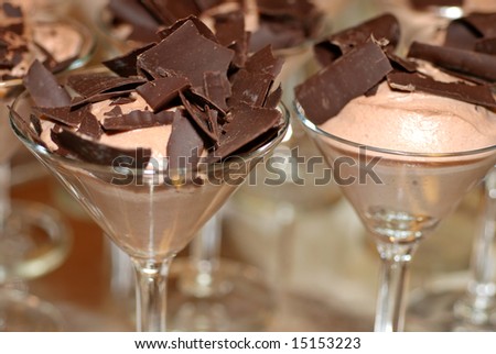 Martini glasses filled with chocolate mousse and dark chocolate shavings