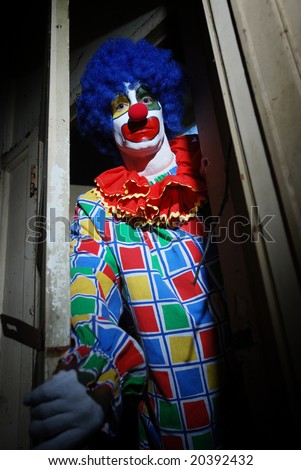 stock photo Scary clown lurking around a haunted house