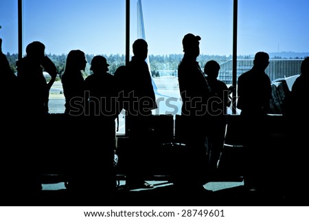 Travelers standing in line at the airport waiting to board an airplane
