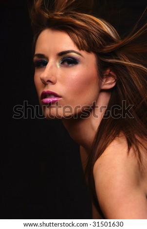 Young brunette model with hair blowing in wind