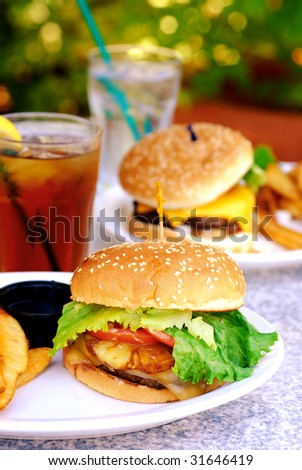Teriyaki burger with large French fries at an outdoor restaurant