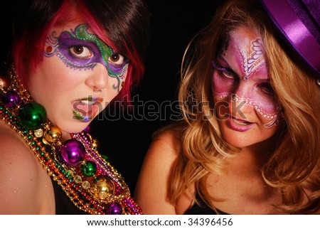 Two woman partying it up for Mardi Gras