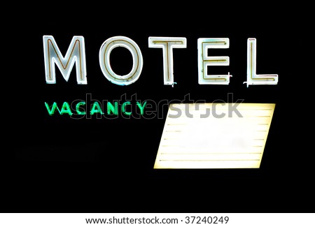 Motel and vacancy neon signs with message board isolated on black background