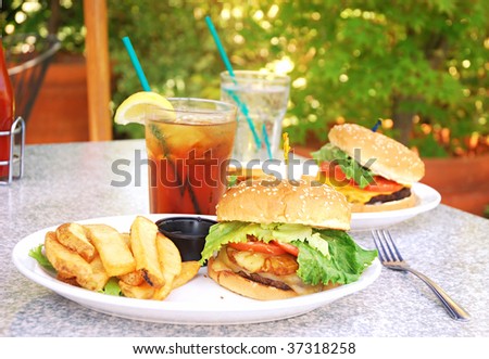 Two burgers on table at outdoor restaurant