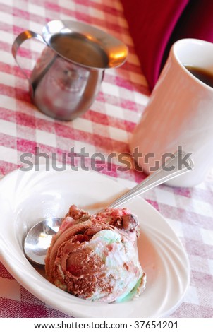 Bowl of spumoni ice cream with cup of coffee and creamer