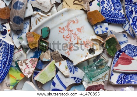 Pieces of broken pottery, mainly blue, red and green.