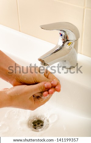 hand washing under the tap closeup