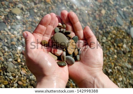vacation concept of pebble in a hand