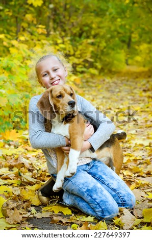 girl with beagle dog in the park