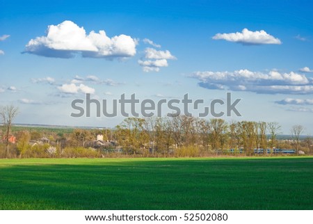 beautiful landscape with sky, clouds, grass, trees and train