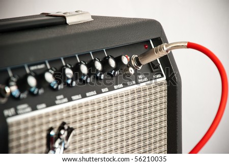 black guitar amplifier with red cord