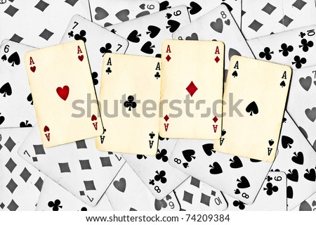 four color aces on a black and white cards background