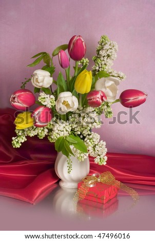 stock photo Bouquet of white and red tulips with lilac and a small gift
