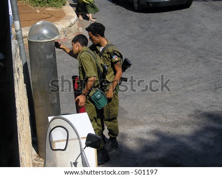 Soldiers in downtown Jerusalem paying for the parking fee
