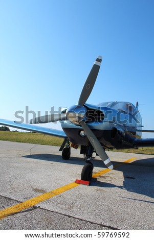 Propeller-driven airplane parked on tarmac