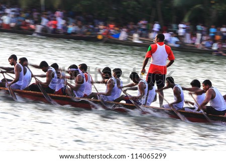KALLADA, INDIA - SEPT 26: Oarsmen of a  participating snake boat team rowing fast  in the Kallada Boat race on September 26, 2012 in Kallada, Kerala, India.