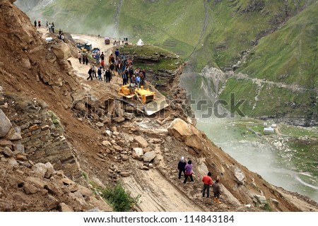 MANALI, INDIA - AUG 29 :  Border Roads Organization clear the road to Leh affected by landslide on August 29, 2012 in Manali, India. Landslides are regular phenomenon of this high altitude region.