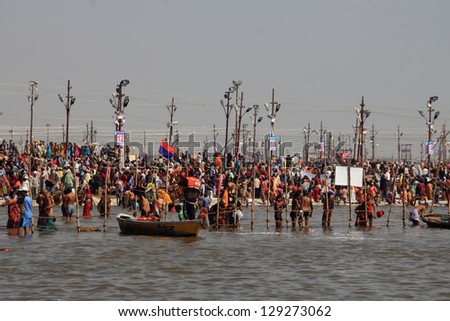 ALLAHABAD - FEB 08: Devotees take the holy bath in the river during the Kumbh Mela on February 08, 2013 in Allahabad, India. Kumbh Mela is considered as the largest human gathering in the world.