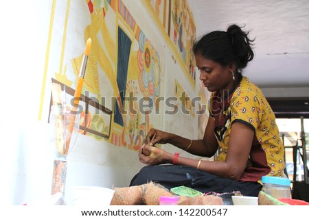 KOTTAYAM, INDIA - MAY 21:Mural artist  Krishna Priya paints on  the wall during the International Mural painters camp organized by Cultural Department of Kerala on May 21,2013 in Kottayam, India.