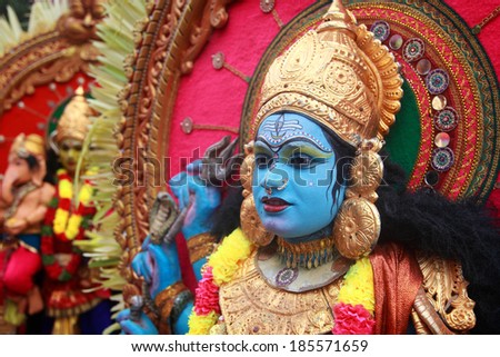 KIDANGANNUR, INDIA - APR 02 : An unidentified man dressed as a Hindu god participates in the cultural procession during  Pallimukkathu  temple festival on April 02, 2014 in Kidangannur, Kerala, India.