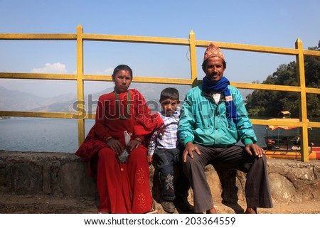 POKHARA, NEPAL - FEB 06: An unidentified Nepalese family come for boating in Begnas Lake on February 06, 2014 in Pokhara, Nepal. Pokhara is a tourist destination in Nepal for trekking and boating.