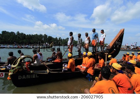 KALLADA, INDIA - SEPT 26: A snake boat team participate in the Kallada Boat race on September 26, 2012 in Kallada, Kerala, India. Boat races are the major sporting event in Kerala during Onam season.