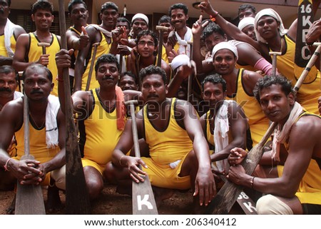 PAYIPPAD, INDIA - SEPT 18: Oarsmen of a snake boat team participate in the Payippad Boat race on September 18, 2013 in Payippad, Kerala, India. Boat races are the major sporting events in Kerala.