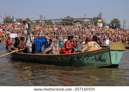 ALLAHABAD - FEB 08: Devotees travel in boat to take bath in the river during the Kumbh Mela on February 08, 2013 in Allahabad, India. Kumbh Mela is the largest religious human gathering in the world.