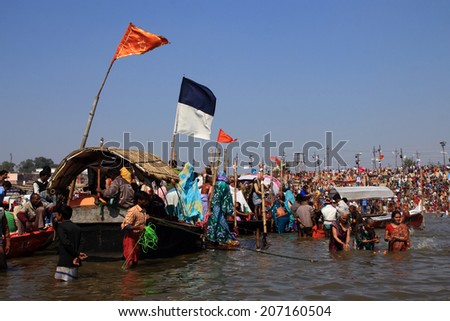 ALLAHABAD - FEB 08: Unidentified devotees take holy bath in the river during the Kumbh Mela on February 08, 2013 in Allahabad, India. Kumbh Mela is the largest religious human gathering in the world.