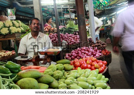 KANCHIPURAM - NOV 26: An unidentified vendor sells vegetables in a market on November 26, 2013 in Kanchipuram,Tamil Nadu, India. Tamil Nadu is the major producer of vegetables in South India.