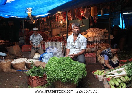 MADGAON - SEPT 21: Unidentified vegetable seller looks for customers in the crowded market in September 21, 2014 in Madgaon, Goa, India. Madgaon market is the most happening market in the south Goa.
