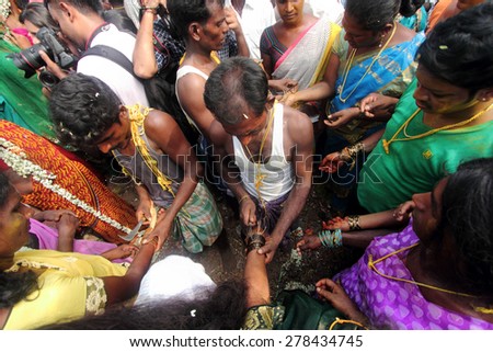 KOOVAGAM, INDIA - MAY 14: Transgenders gets their bangles broken as a ritual to mourn the death of Lord Aravan in their festival held at Koothandavar temple on May 14, 2014 in Koovagam,Tamil Nadu.