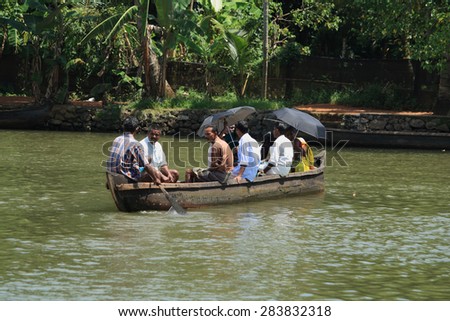 ALLEPPEY, INDIA -JUL 11 : A boat man transport people from one side to other in the backwaters on July 11, 2010 in Alleppey, India. People of the region depend on boats for their transporting needs