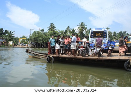 ALLEPPEY, INDIA -JUL 11 : People of the backwater region transport their vehicles in a big boat on July 11, 2010 in Alleppey, India. People of the region depend on boats for their transporting needs.