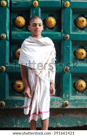 CHENNAI, INDIA - FEB 09 : An unidentified Brahmin priest sits outside the Kapaleeshawar temple on February 9, 2012 in Chennai, India. Brahmins are the appointed priests in most of the temples in India